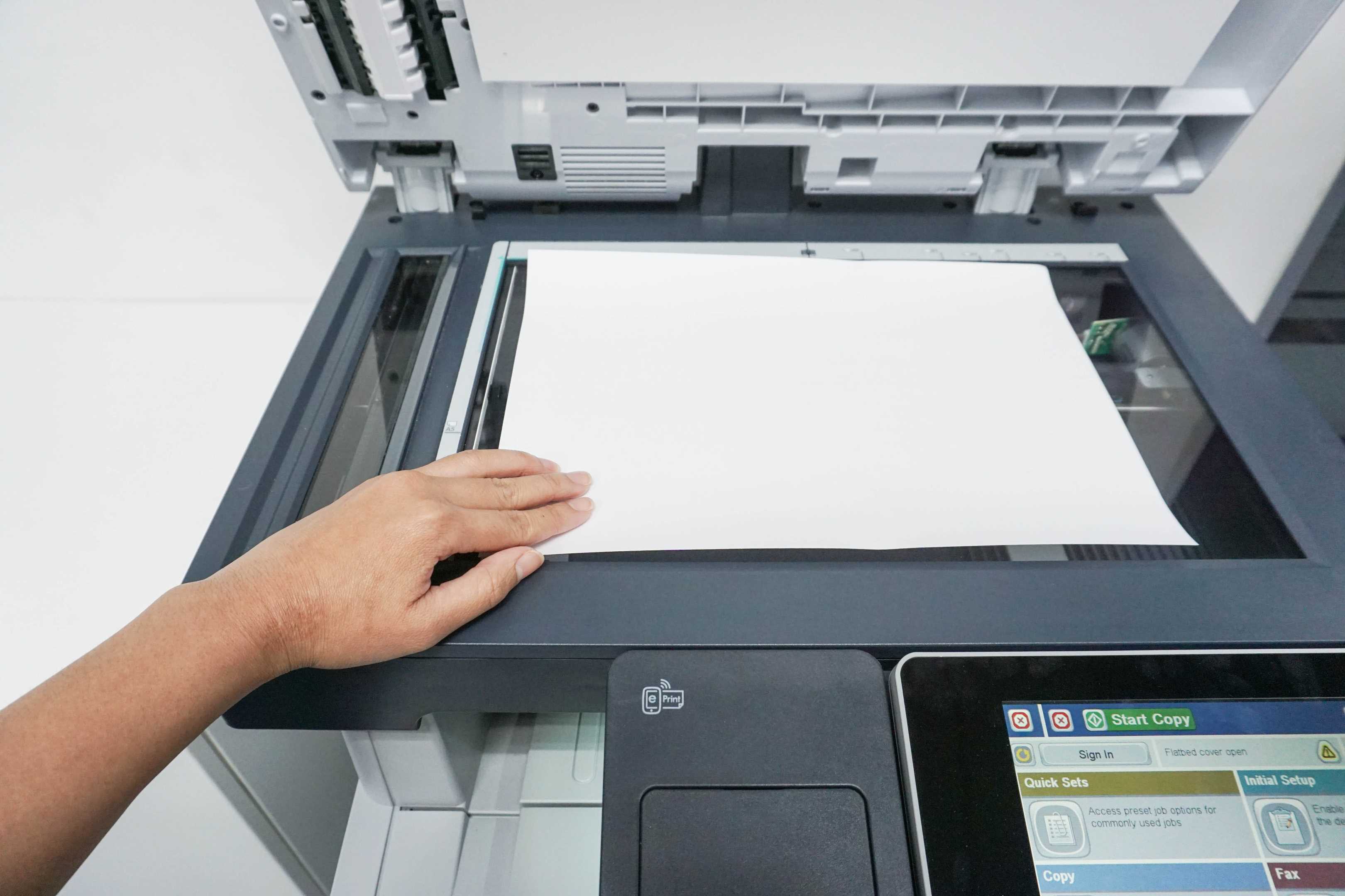 Человек Кладец бумагу в принтер