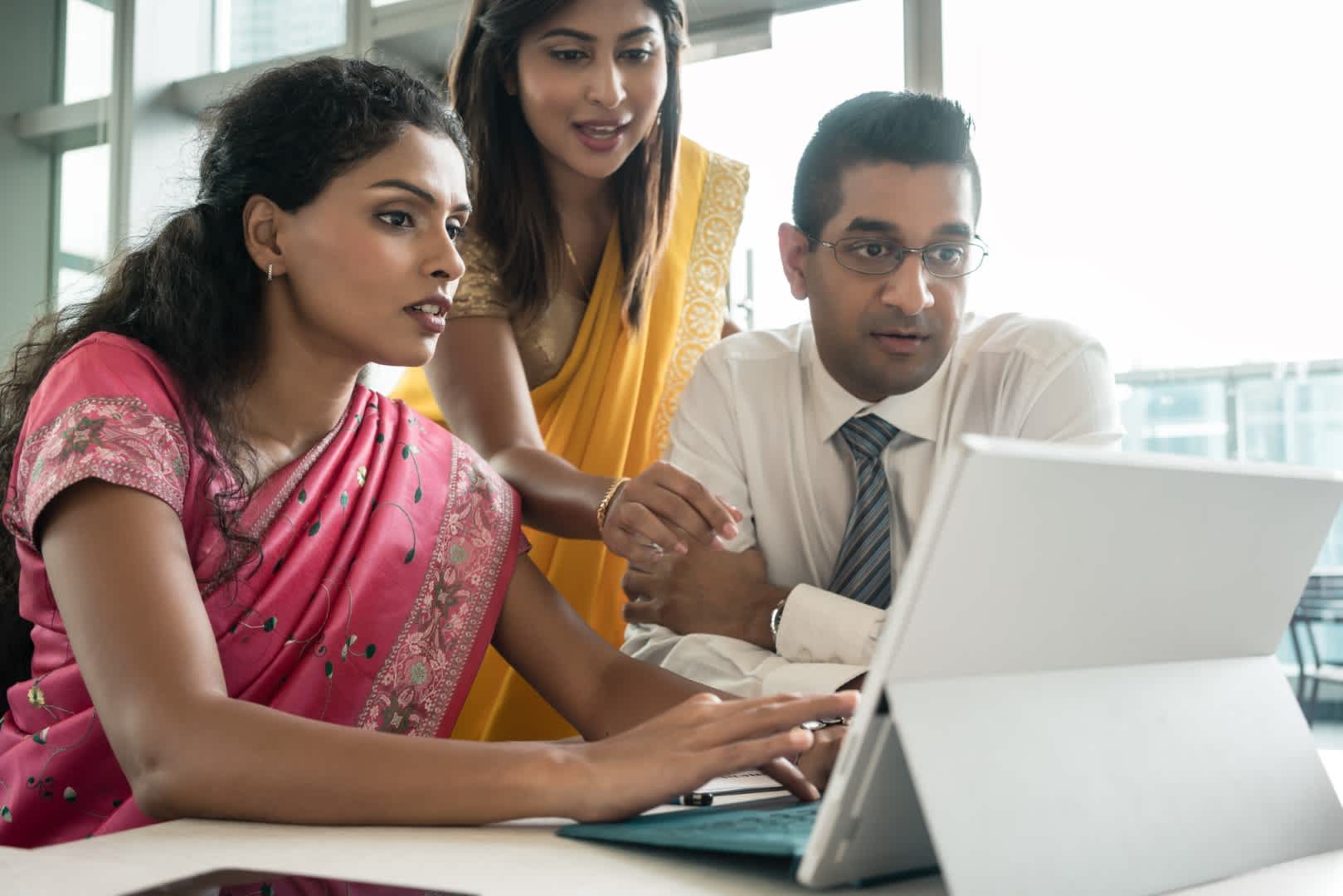 Indian business professionals collaborating on technology