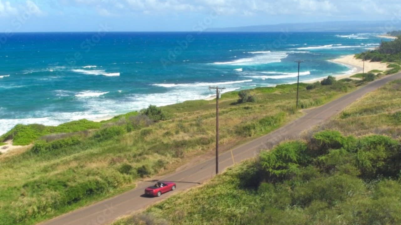 Maui Car Rental - Convertible on remote island road.